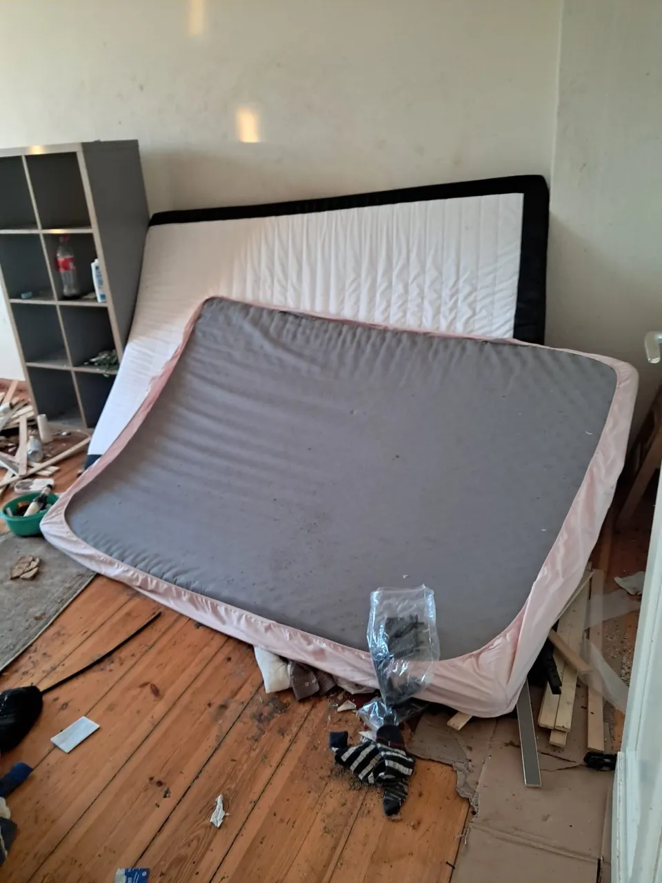 Zimmer mit alten Matratzen und Unrat vor der Entrümpelung